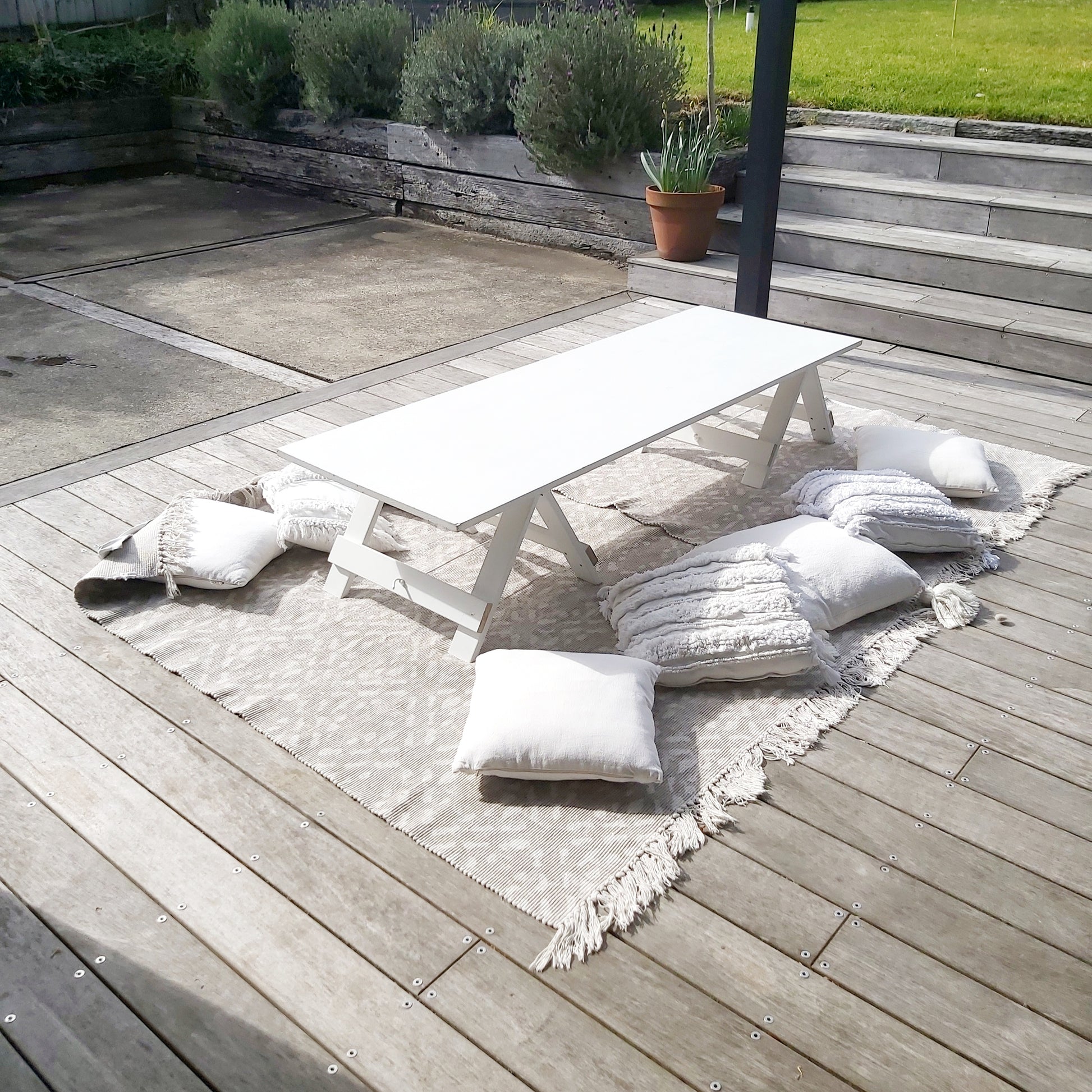 Low picnic table with rugs and cushions 
