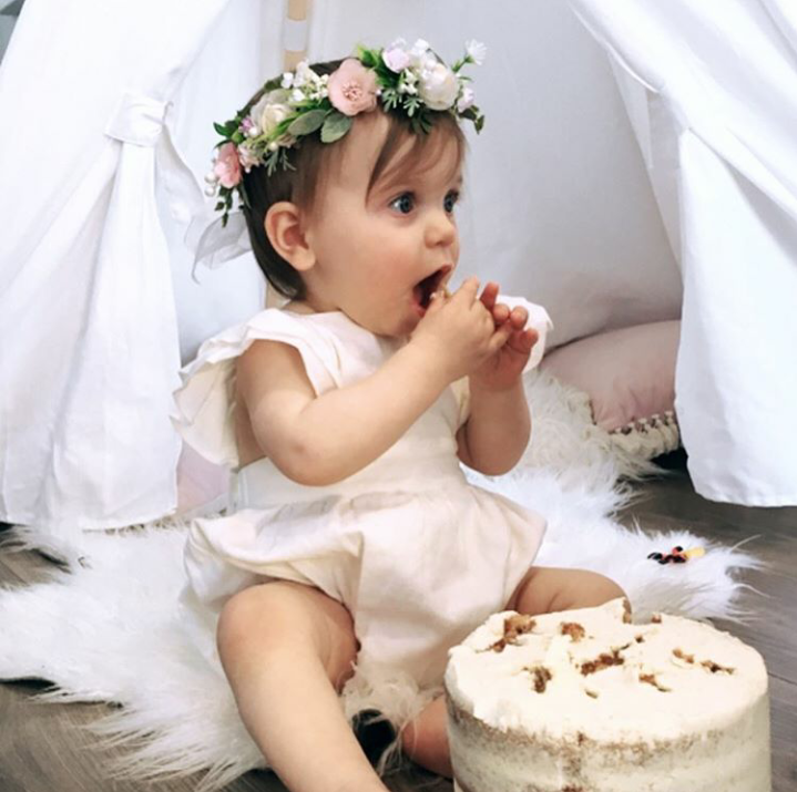 baby eating cake in teepee