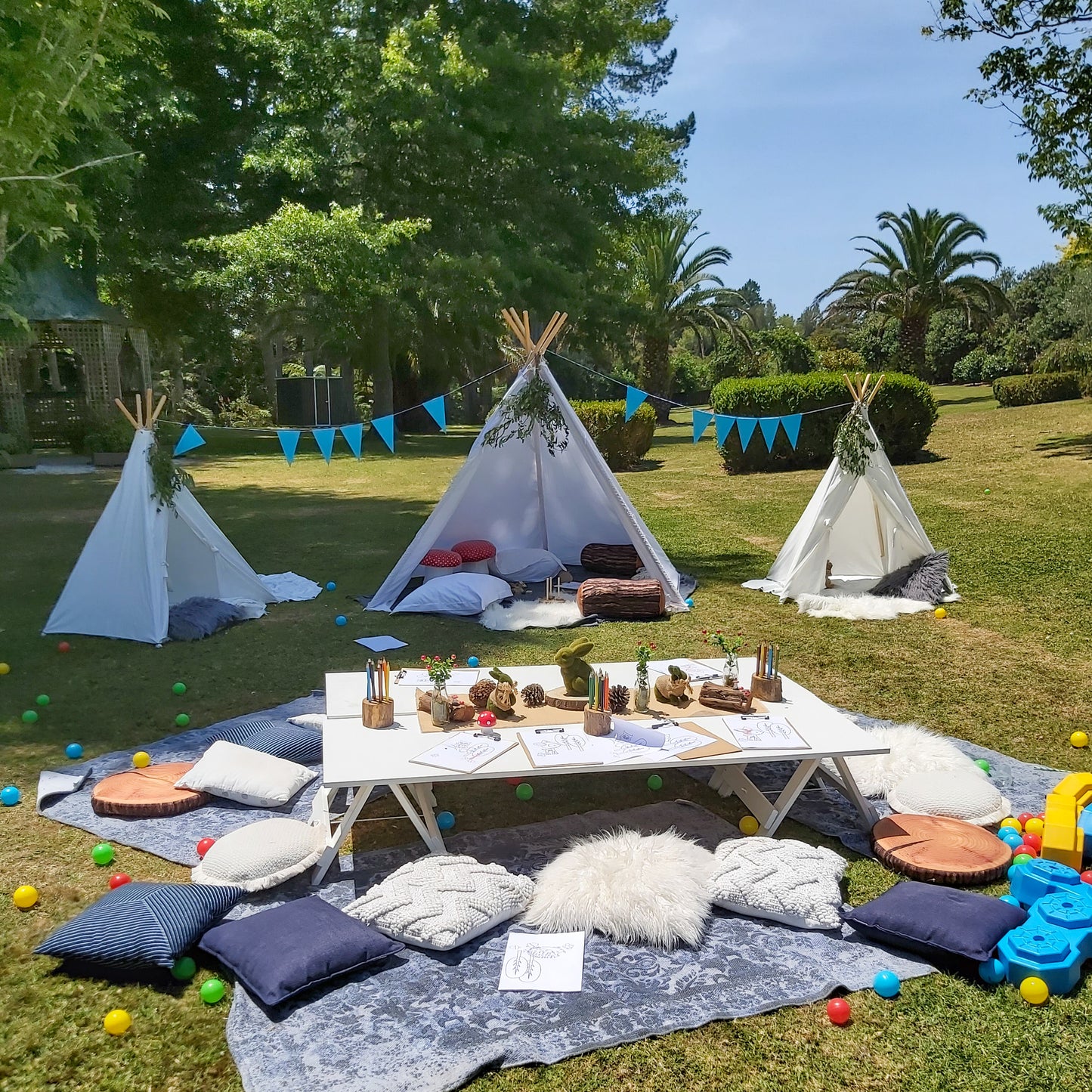 Party set up for kids including teepees and tables 