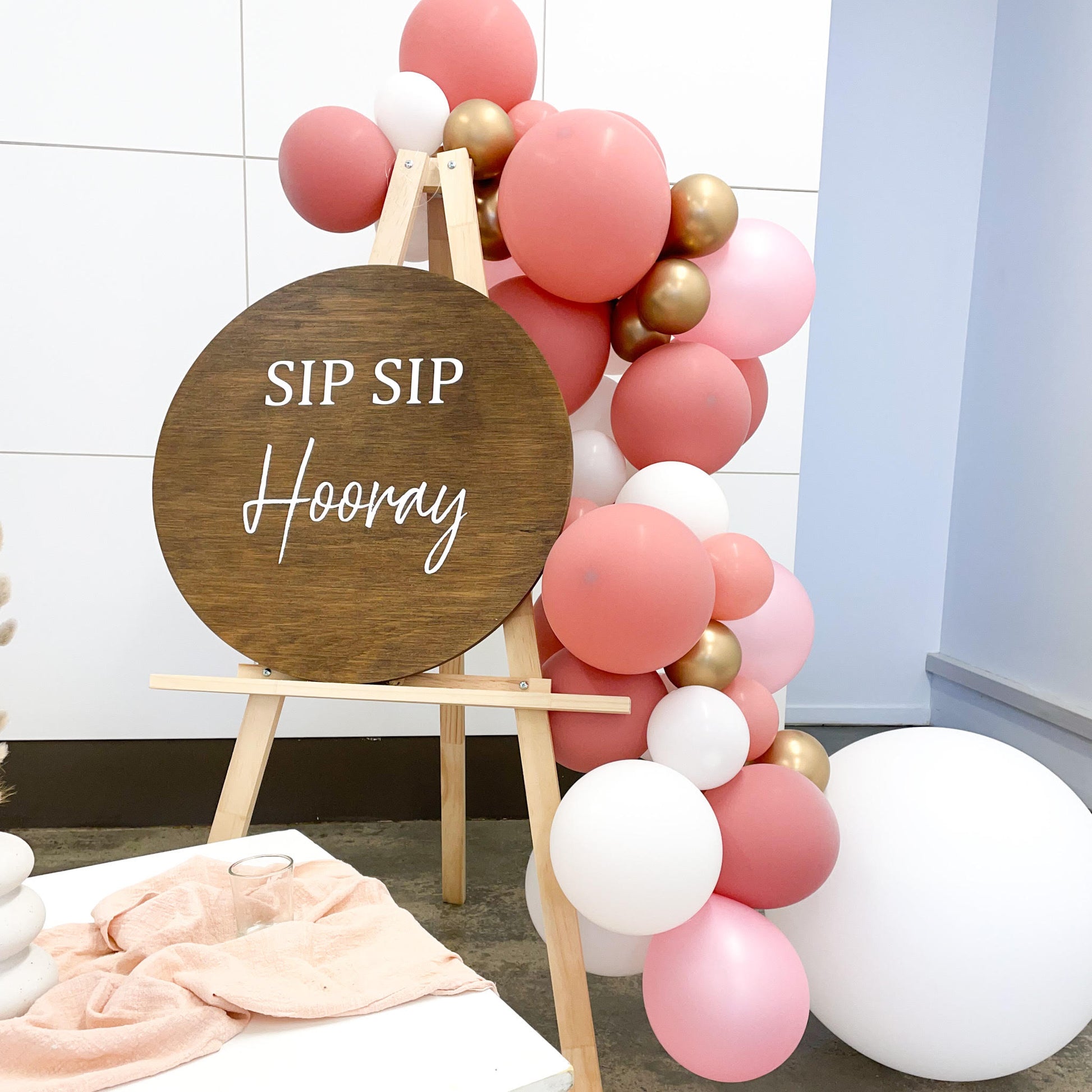 Sip Sip Hooray sign on easel with balloons 
