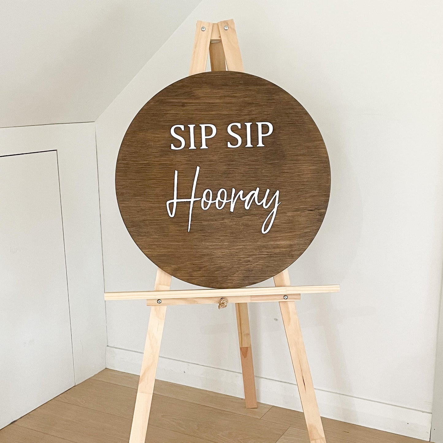Sip sip hooray on round sign 