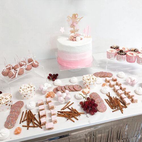 Gorgeous party food in pink tones set up on table with acrylic risers  - available to hire Auckland