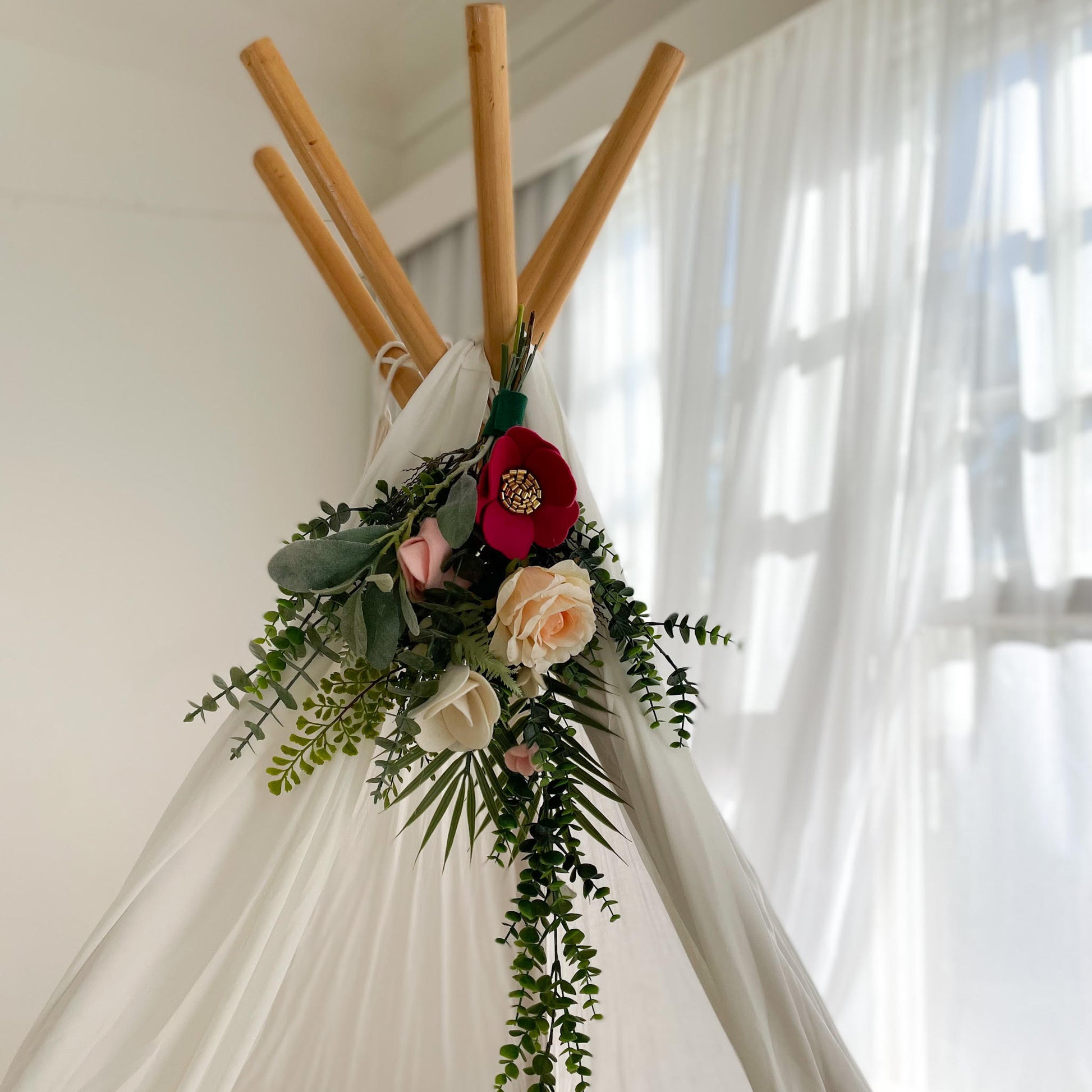 Handmade floral topper on teepee